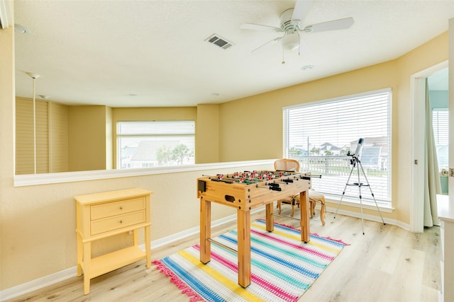 playroom with wood finished floors, baseboards, and ceiling fan