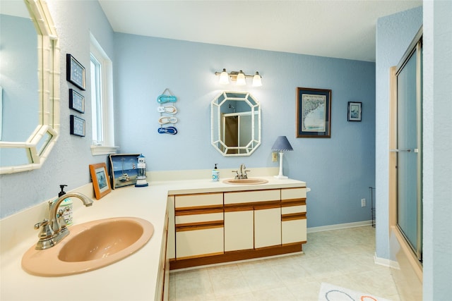 bathroom featuring a shower with door, vanity, and tile patterned flooring