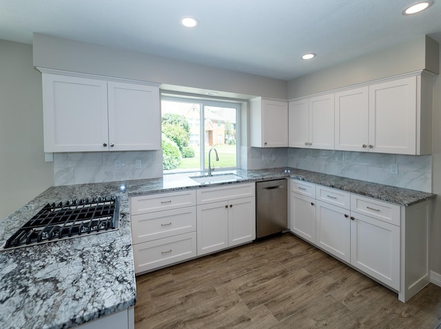 2414 Shoal Creek Dr, League City, TX 77573 - kitchen with a sink, stainless steel appliances, white cabinetry, tasteful backsplash, and recessed lighting