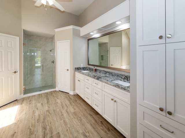 2414 Shoal Creek Dr, League City, TX 77573 - full bath with a stall shower, ceiling fan, wood finished floors, and double vanity