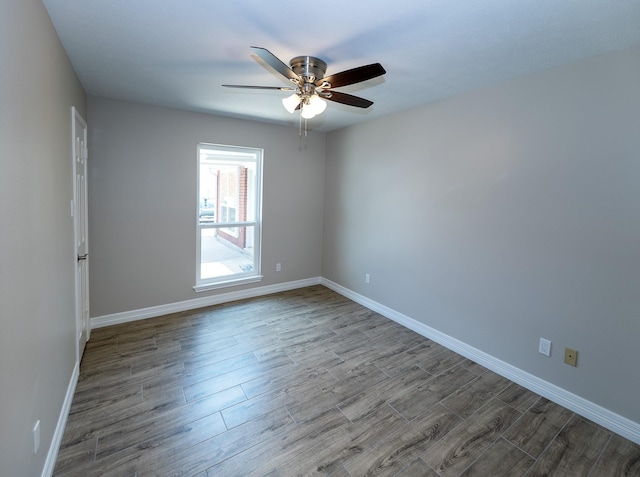 2414 Shoal Creek Dr, League City, TX 77573 - empty room featuring dark wood-type flooring, ceiling fan, and baseboards
