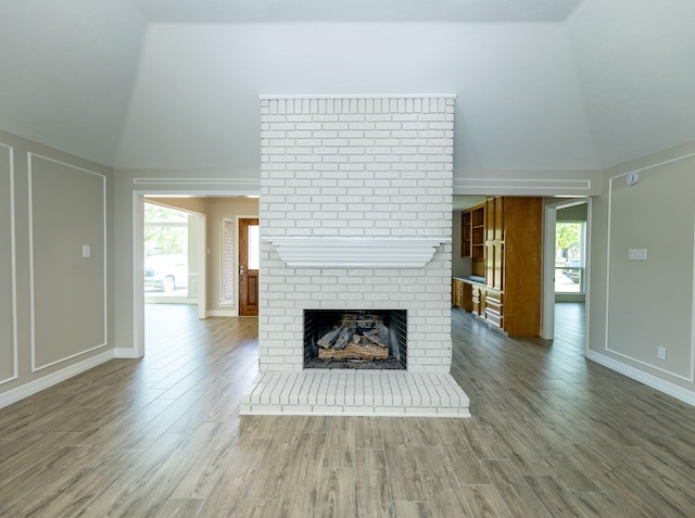 2414 Shoal Creek Dr, League City, TX 77573 - unfurnished living room with a fireplace, wood finished floors, vaulted ceiling, and baseboards