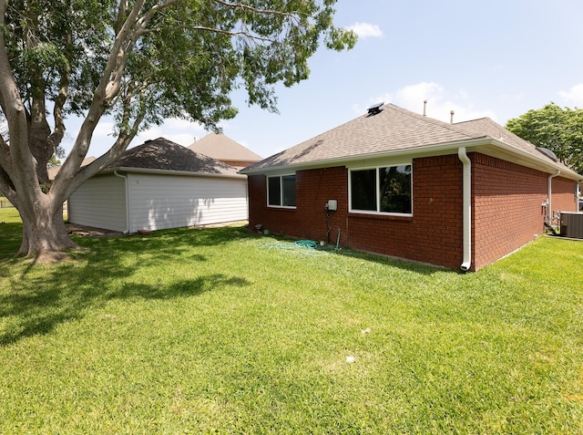 2414 Shoal Creek Dr, League City, TX 77573 - back of house featuring cooling unit, brick siding, a yard, and roof with shingles