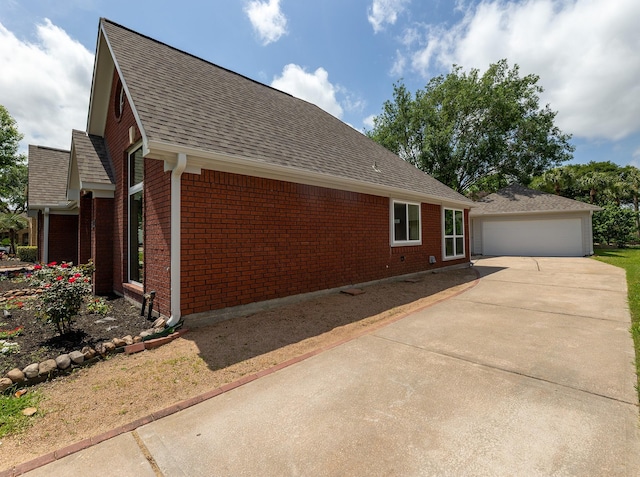 2414 Shoal Creek Dr, League City, TX 77573 - view of side of home featuring brick siding, roof with shingles, and concrete driveway