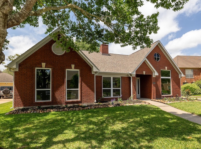 2414 Shoal Creek Dr, League City, TX 77573 - traditional-style home featuring brick siding, a chimney, a front lawn, and roof with shingles