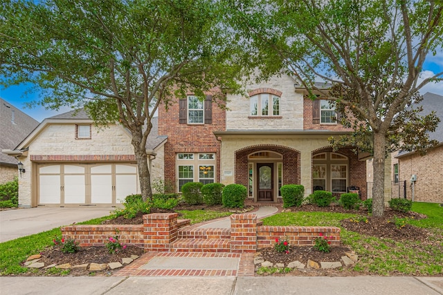 12607 Cove Landing Dr, Cypress, TX 77433 - view of front of house featuring driveway, a garage, brick siding, and stone siding
