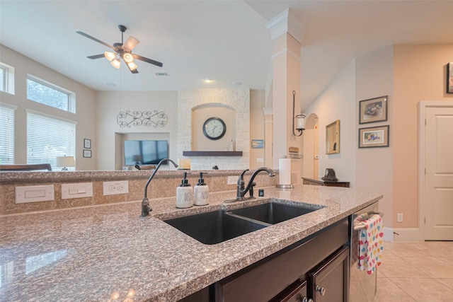 12607 Cove Landing Dr, Cypress, TX 77433 - kitchen with a sink, a ceiling fan, stainless steel dishwasher, light stone countertops, and light tile patterned flooring