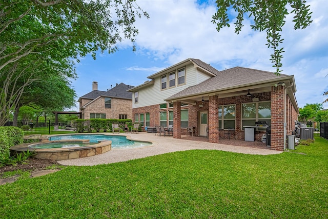 12607 Cove Landing Dr, Cypress, TX 77433 - back of property with a ceiling fan, brick siding, a patio, cooling unit, and a pool with connected hot tub