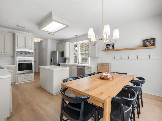dining area featuring light wood finished floors