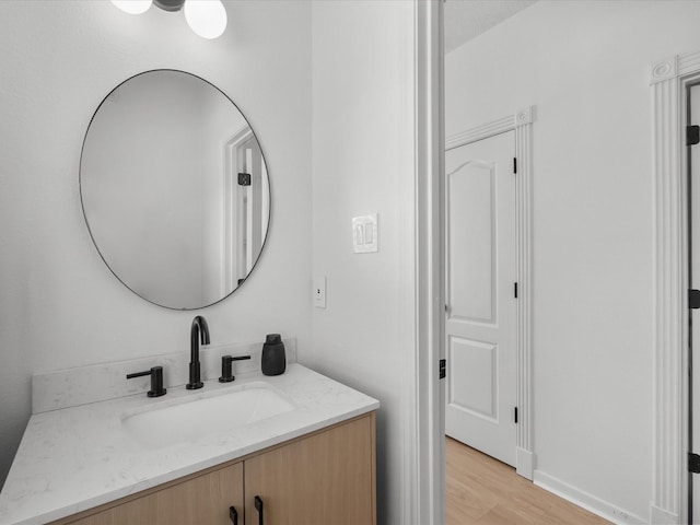 bathroom with wood finished floors and vanity
