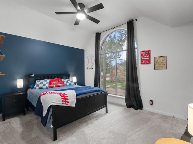 bedroom featuring lofted ceiling, carpet, baseboards, and a ceiling fan