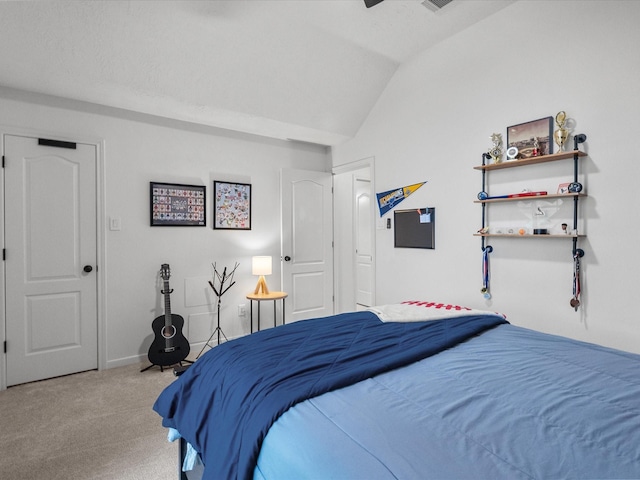 carpeted bedroom featuring vaulted ceiling and baseboards