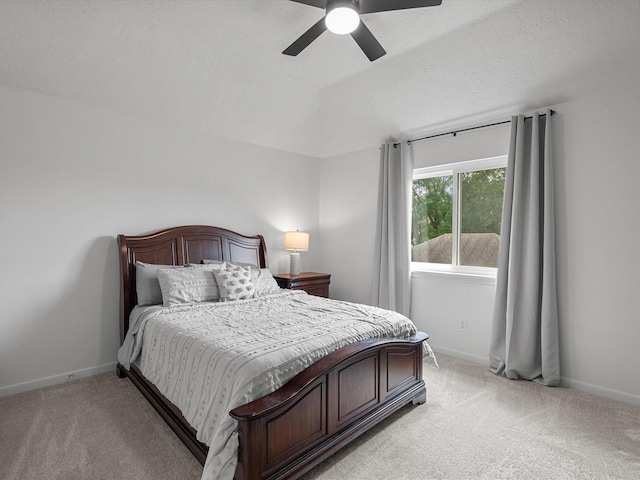 bedroom with light colored carpet, baseboards, and a ceiling fan