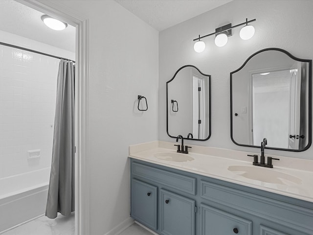 bathroom featuring double vanity, shower / tub combo, a textured ceiling, and marble finish floors