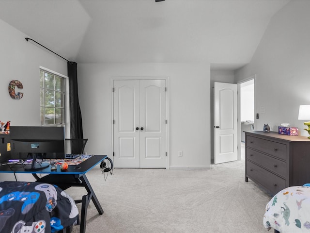 carpeted bedroom with baseboards and vaulted ceiling