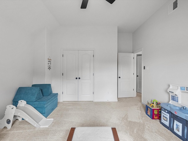 unfurnished room with a ceiling fan, carpet flooring, and vaulted ceiling