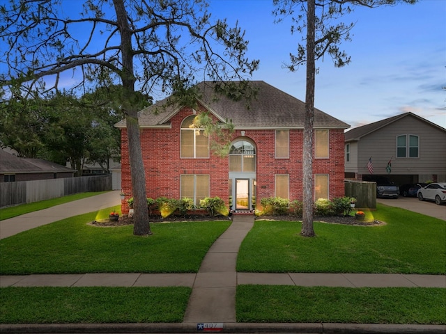 view of front of home featuring brick siding and roof with shingles