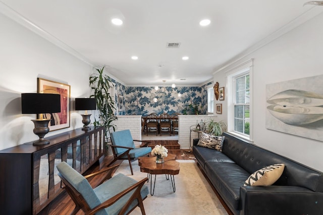 living room with ornamental molding and recessed lighting