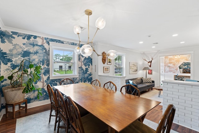 dining space with healthy amount of natural light, ornamental molding, wood finished floors, baseboards, and wallpapered walls
