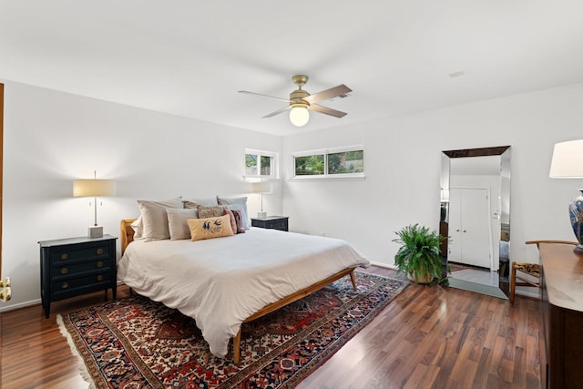 bedroom featuring wood finished floors, ceiling fan, and baseboards