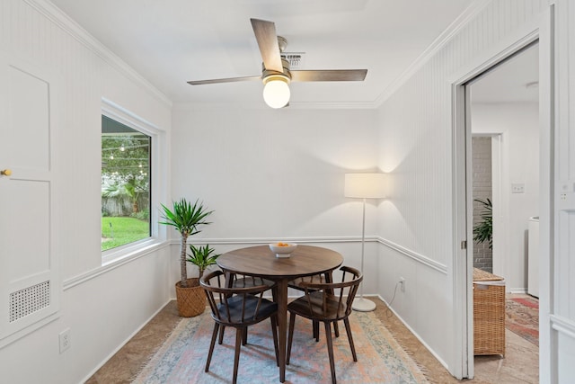 dining room featuring ornamental molding, a ceiling fan, and baseboards
