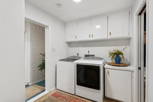 clothes washing area with washer and clothes dryer and cabinet space