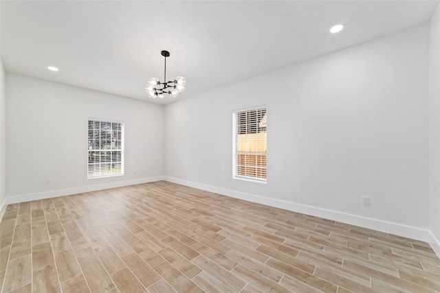 1003 Kelley St, Houston, TX 77009 - empty room with light wood-type flooring, a chandelier, baseboards, recessed lighting, and a heating unit