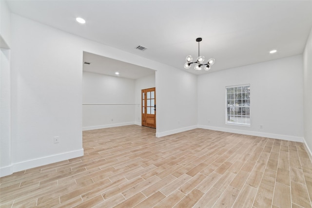 1003 Kelley St, Houston, TX 77009 - spare room with light wood finished floors, a chandelier, baseboards, and recessed lighting