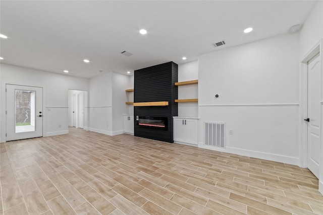 1003 Kelley St, Houston, TX 77009 - unfurnished living room with a fireplace, light wood-type flooring, recessed lighting, and baseboards