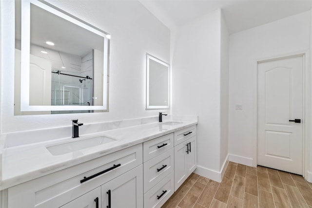 1003 Kelley St, Houston, TX 77009 - full bath featuring a shower stall, double vanity, wood finished floors, and baseboards