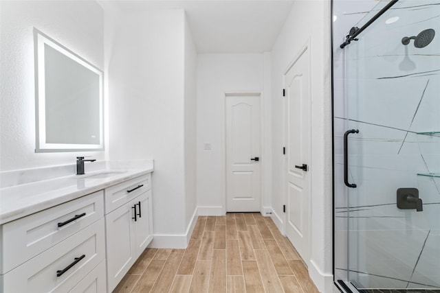 1003 Kelley St, Houston, TX 77009 - full bath with a shower stall, wood finished floors, vanity, and baseboards