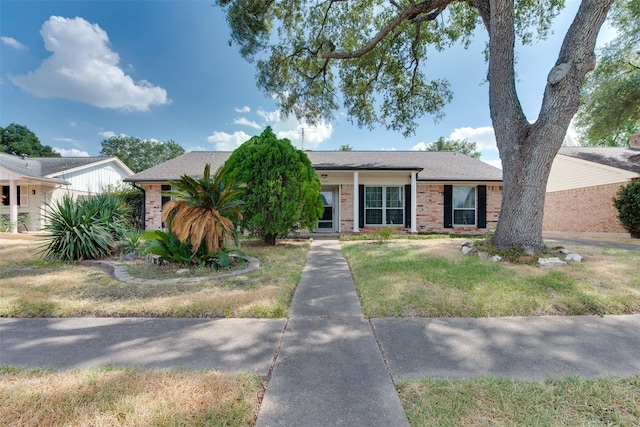 ranch-style home featuring brick siding