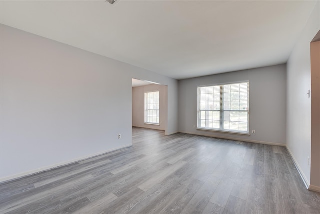 unfurnished room with wood finished floors and baseboards