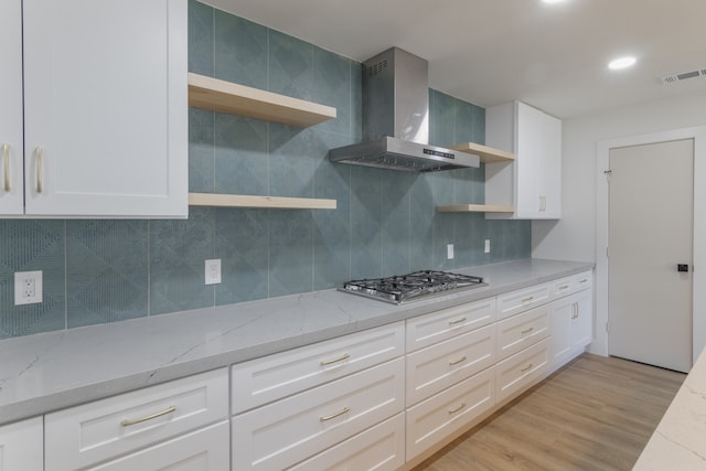1710 Hafner Dr, Houston, TX 77055 - kitchen featuring open shelves, stainless steel gas cooktop, wall chimney exhaust hood, decorative backsplash, and light stone countertops