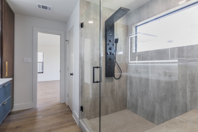 1710 Hafner Dr, Houston, TX 77055 - bathroom with wood finished floors, a shower stall, baseboards, and vanity
