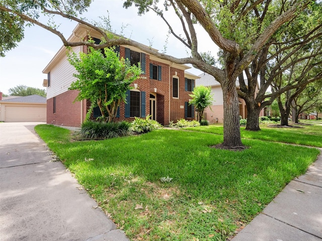 23334 Fairbranch Dr, Katy, TX 77494 - view of front of house featuring brick siding, a front lawn, an outbuilding, and a detached garage