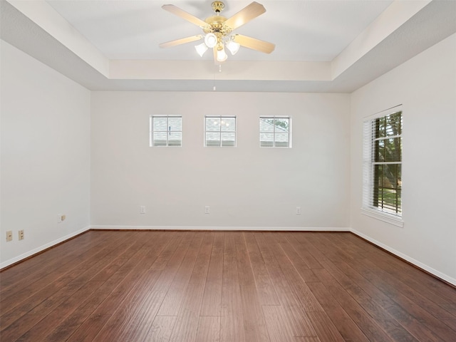 23334 Fairbranch Dr, Katy, TX 77494 - unfurnished room with a raised ceiling, baseboards, ceiling fan, and dark wood finished floors
