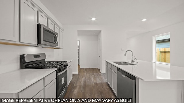 1346 Heather Rosewood Ln, Conroe, TX 77301 - kitchen with appliances with stainless steel finishes, a sink, light countertops, an island with sink, and dark wood-type flooring