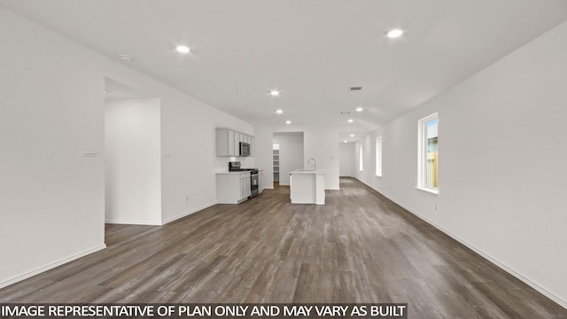 1346 Heather Rosewood Ln, Conroe, TX 77301 - unfurnished living room with a sink, dark wood-style floors, recessed lighting, and baseboards