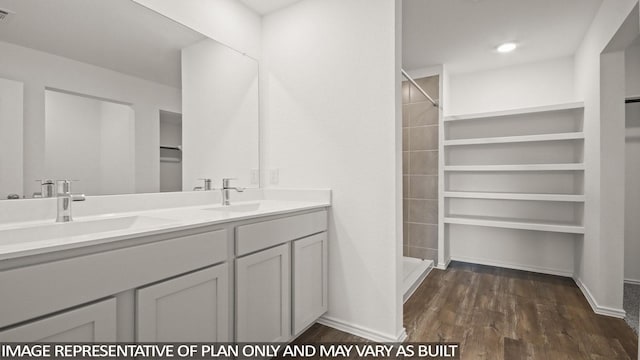 1346 Heather Rosewood Ln, Conroe, TX 77301 - full bath with wood finished floors, a stall shower, a spacious closet, double vanity, and baseboards