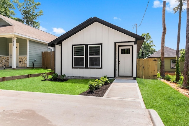 view of front of house featuring board and batten siding and a gate