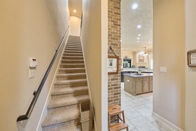stairs with tile patterned floors, recessed lighting, and baseboards