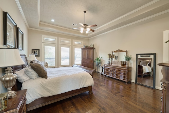 bedroom with a tray ceiling, crown molding, wood finished floors, a textured ceiling, and recessed lighting