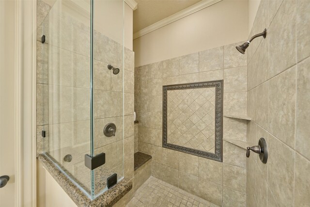 bathroom featuring crown molding and a stall shower