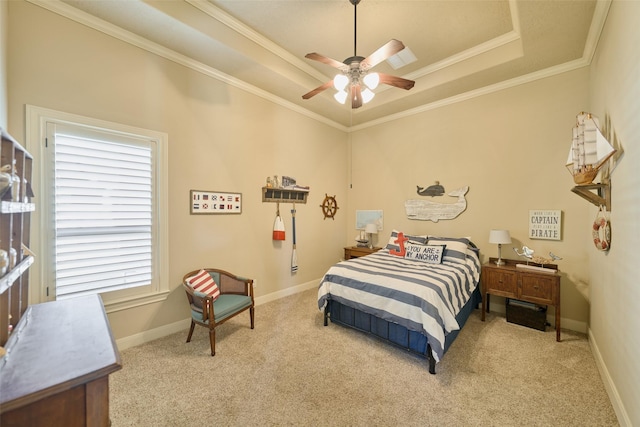 bedroom with a tray ceiling, carpet, crown molding, and baseboards