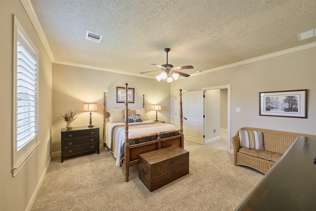 carpeted bedroom with a textured ceiling, crown molding, baseboards, and a ceiling fan