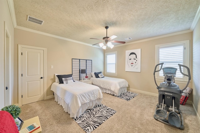 carpeted bedroom with ornamental molding, baseboards, ceiling fan, and a textured ceiling
