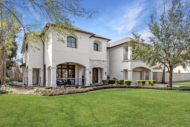 5105 Pocahontas St, Bellaire, TX 77401 - view of front of home with stucco siding, stone siding, and a balcony
