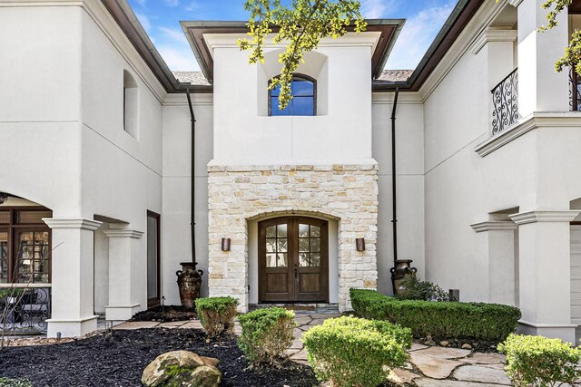 5105 Pocahontas St, Bellaire, TX 77401 - property entrance with stone siding, french doors, and stucco siding