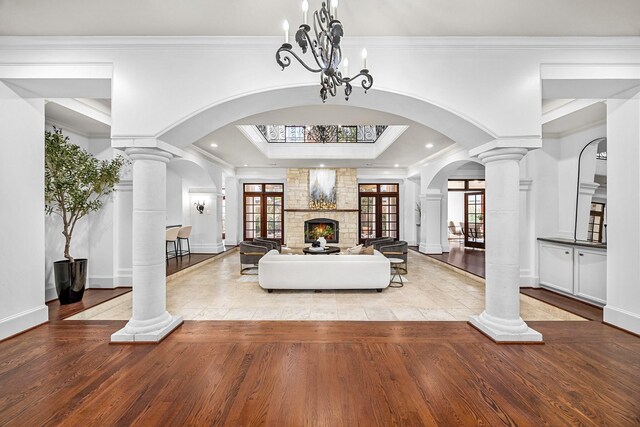 5105 Pocahontas St, Bellaire, TX 77401 - living room with arched walkways, wood finished floors, ornamental molding, decorative columns, and recessed lighting